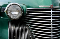 Color photograph of a vintage Cadillac automobile grill and headlight by Crystal Nederman
