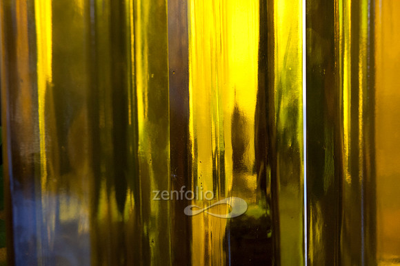 Photograph of sunshine through bottles of olive oil by Crystal Nederman
