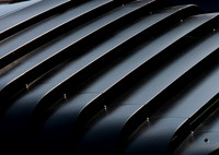 Color photograph of black window louvers from a Chevrolet Corvette by Crystal Nederman